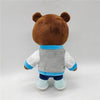 A brown bear plush toy with blue accents and a gray vest, shown from the back.