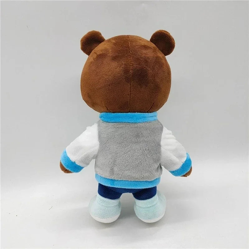 A brown bear plush toy with blue accents and a gray vest, shown from the back.