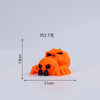 An orange mini monster figurine resembling a spider or skeleton, measuring approximately 3.7 inches tall.