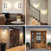 A collection of vintage LED rectangle wall sconces mounted on a light-colored wall and an exterior wooden door.