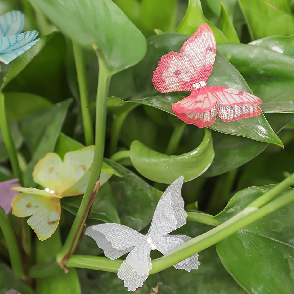 A close-up of various natural butterfly flowers in shades of pink, white, and yellow against green foliage.