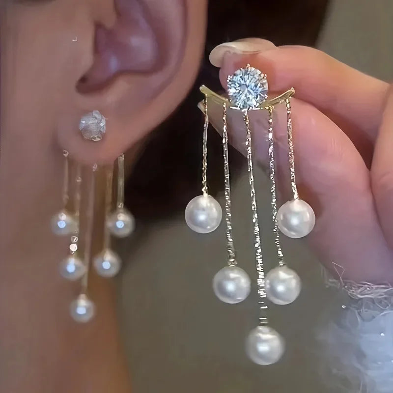 Silver needle pearl tassel earrings featuring a stud and multiple dangling pearls