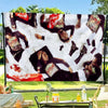 Bold wall art featuring a flag design with red and black elements displayed outdoors.
