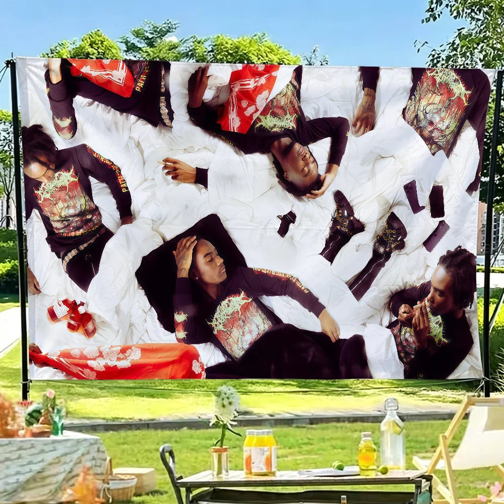 Bold wall art featuring a flag design with red and black elements displayed outdoors.
