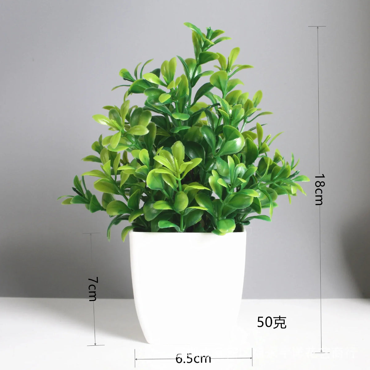 A potted artificial bonsai plant with bright green eucalyptus leaves in a white cylindrical pot.