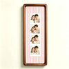 A vertical photo strip frame with a walnut wood border and pink and white striped background, displaying six portrait photos 