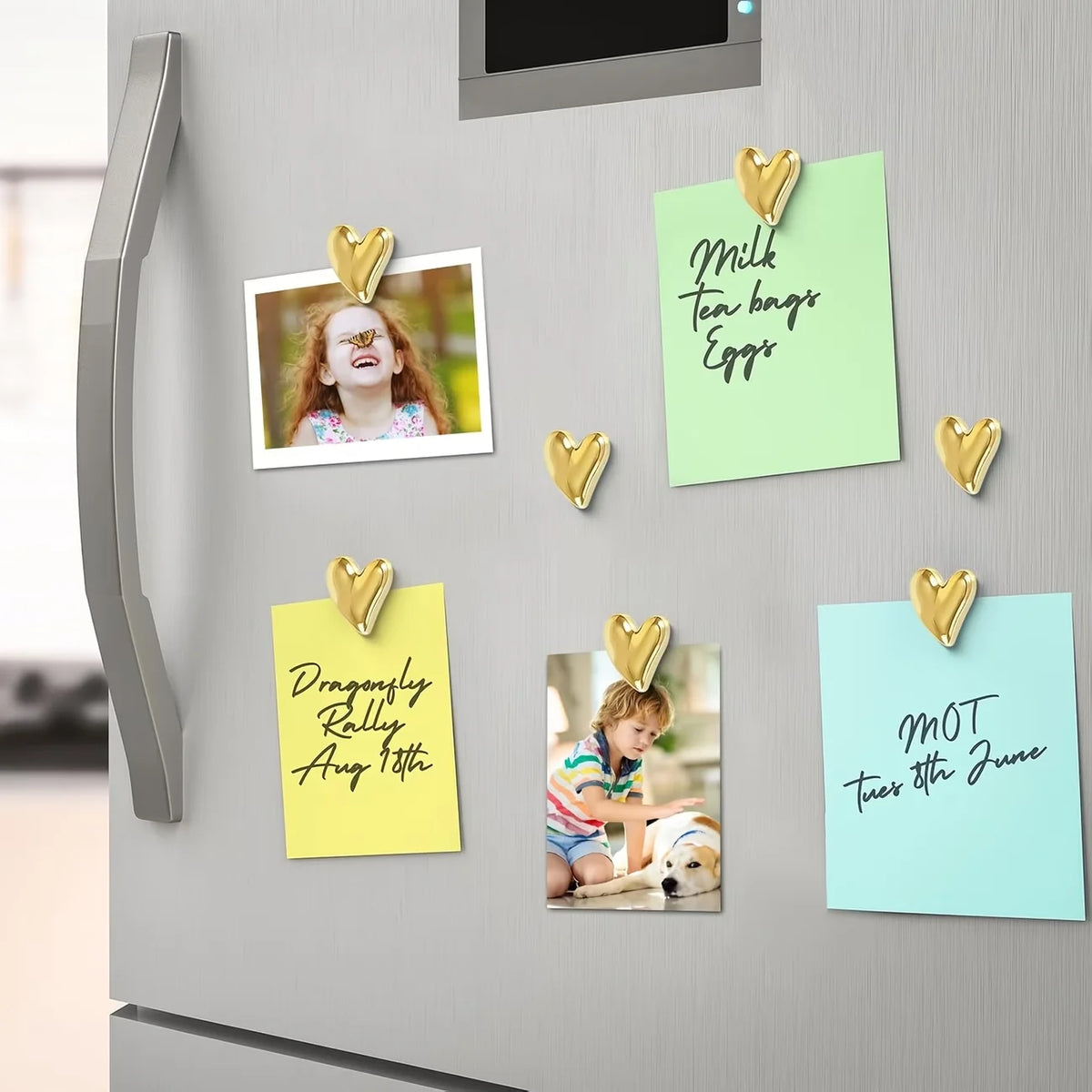 A set of gold heart fridge magnets featuring text like Milk Tea Bags Eggs and MOT Tues 8th June