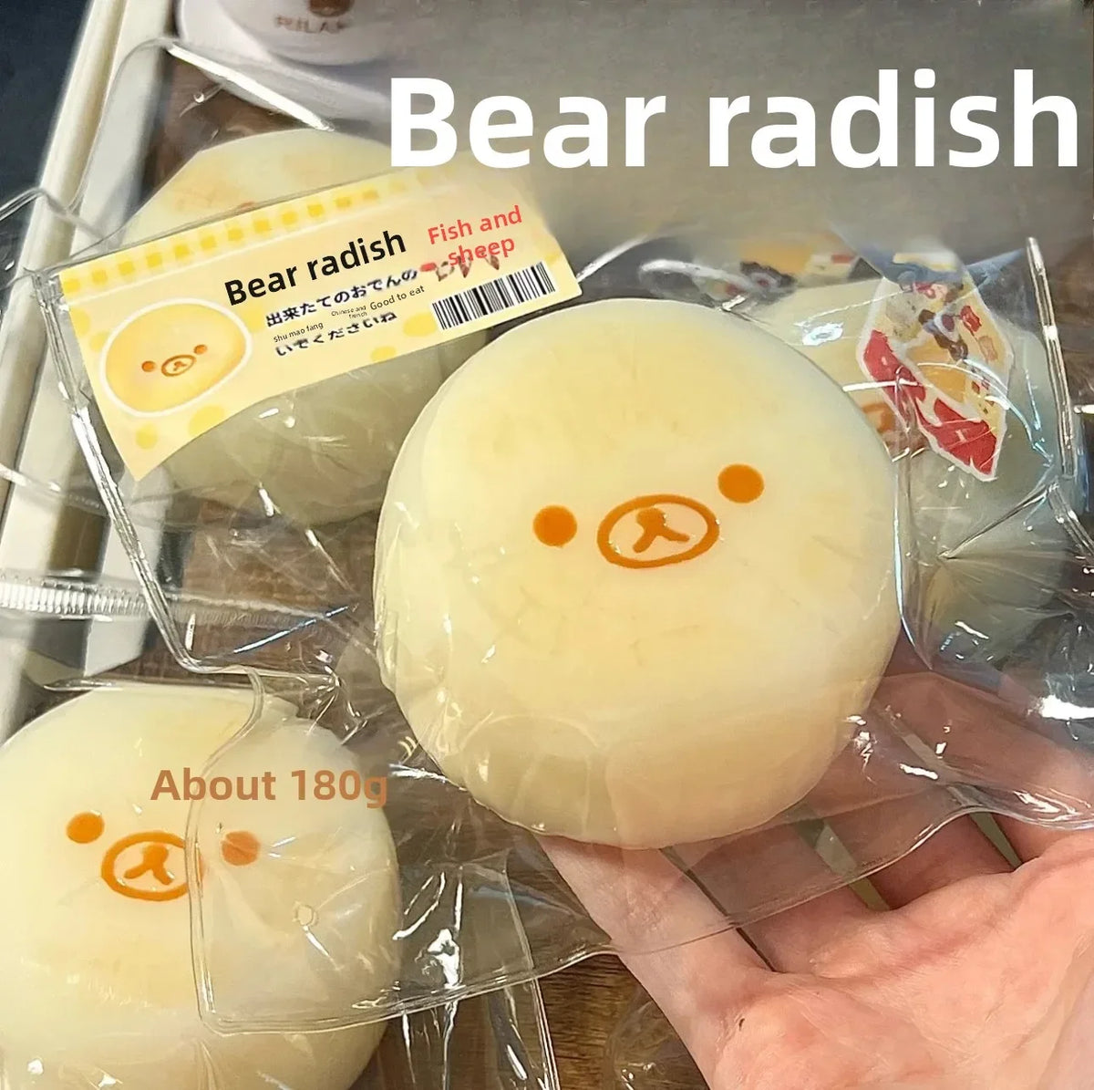 A hand holds a large, pale yellow bear radish squishy toy packaged for sale.