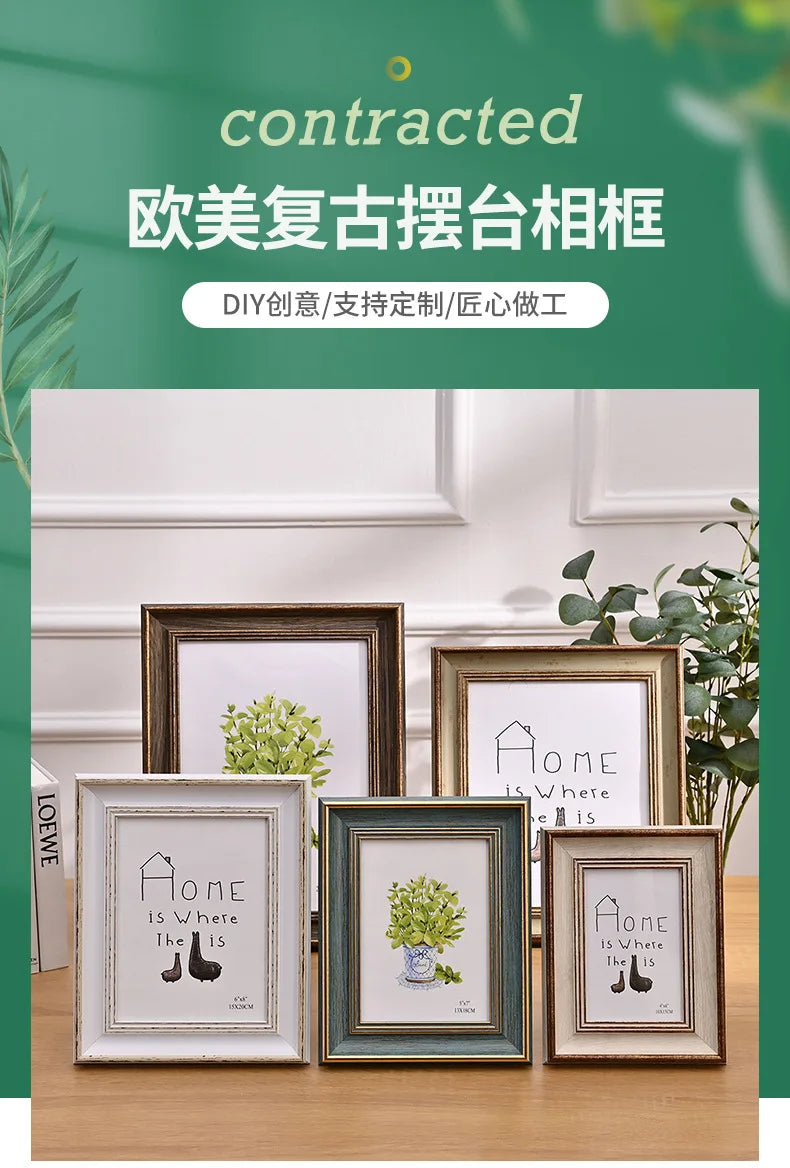 A set of four handcrafted wooden photo frames with white mats and dark wood borders displayed on a wooden surface.