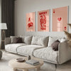 A modern living room features a light sofa and wooden table with framed retro letter art canvases on the wall.