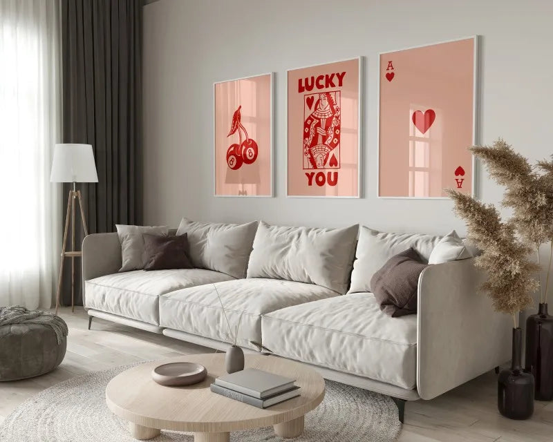 A modern living room features a light sofa and wooden table with framed retro letter art canvases on the wall.