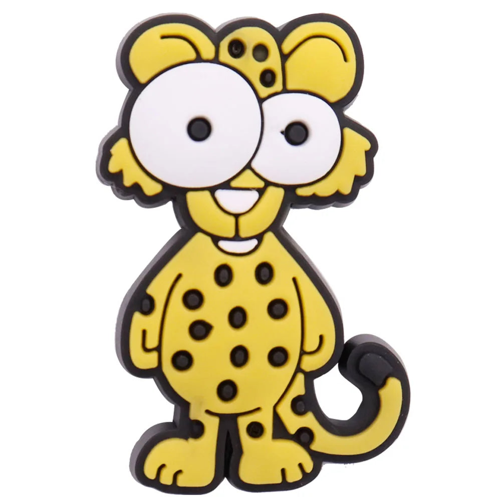 A yellow cartoon dinosaur charm with large eyes and black spots.