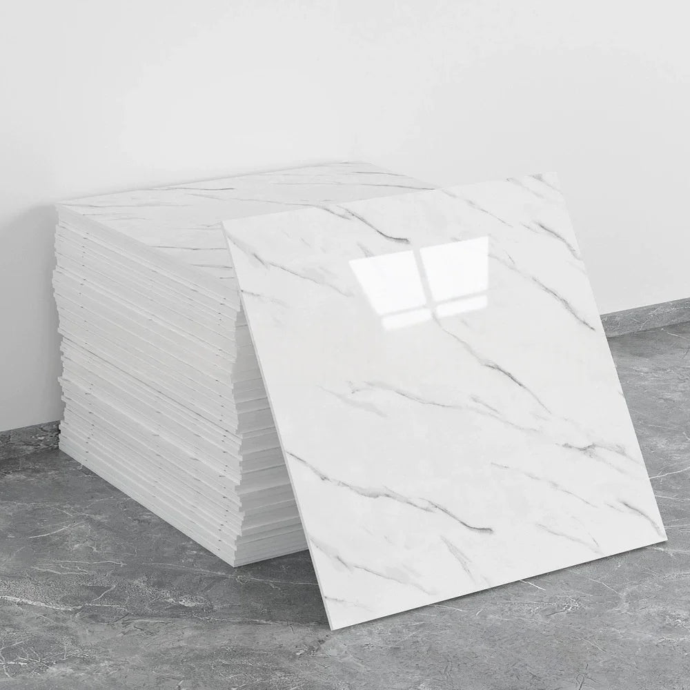 A stack of white marble tile stickers on a gray floor.