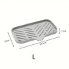 A rectangular silicone faucet splash guard and drying mat with parallel grooves.