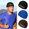 A man wearing a black handmade crochet beanie hat and a blue athletic shirt.