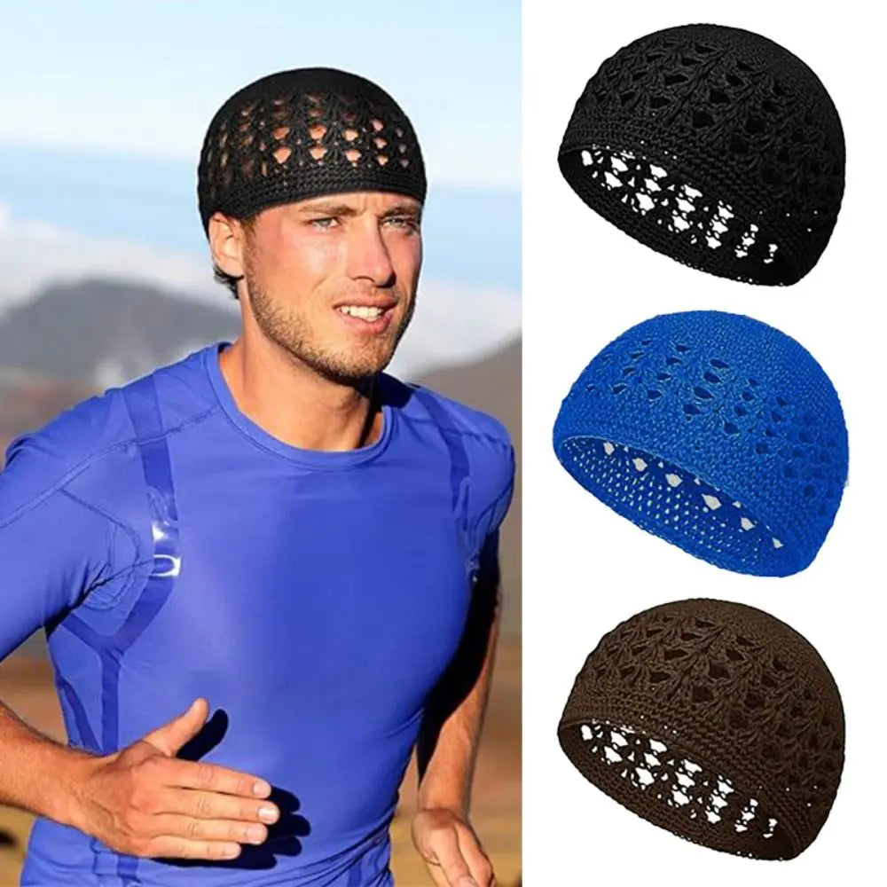A man wearing a black handmade crochet beanie hat and a blue athletic shirt.