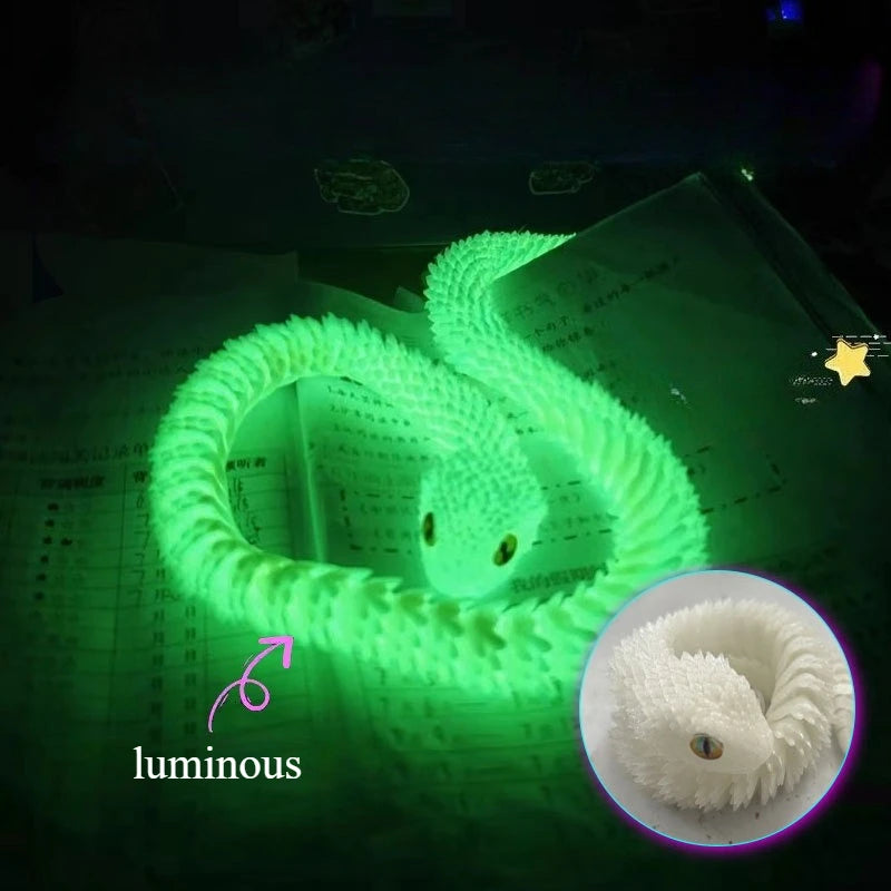 A luminous green snake art model is coiled on a sheet of paper, highlighting its texture and form.