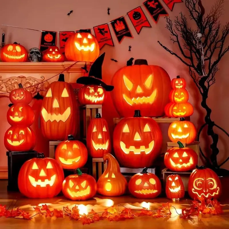 A glowing orange Halloween pumpkin lantern decorated with carved faces sits on a wooden surface.