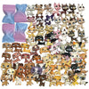 A collection of mini bobblehead dog and cat figures in various colors and breeds.