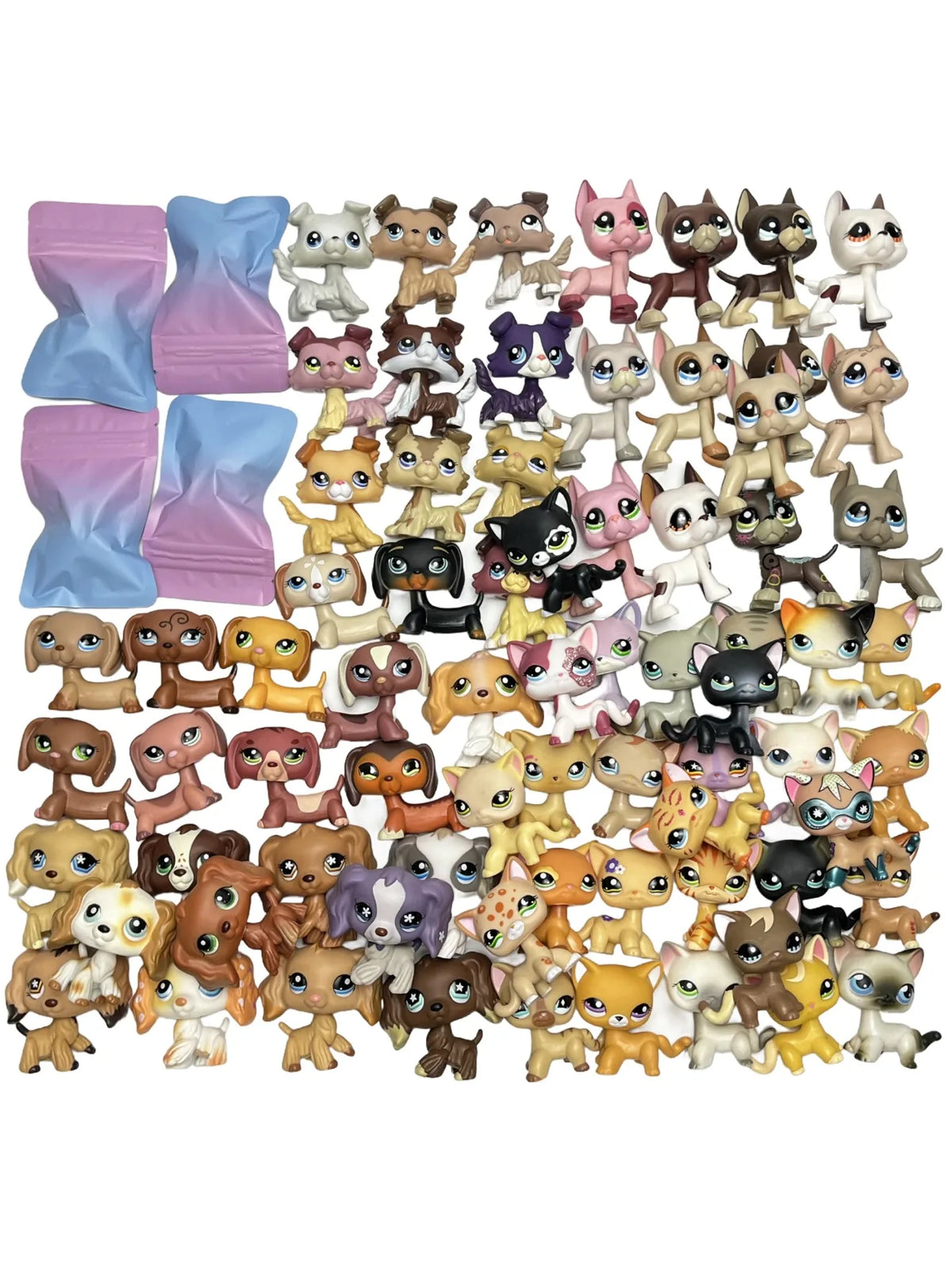 A collection of mini bobblehead dog and cat figures in various colors and breeds.