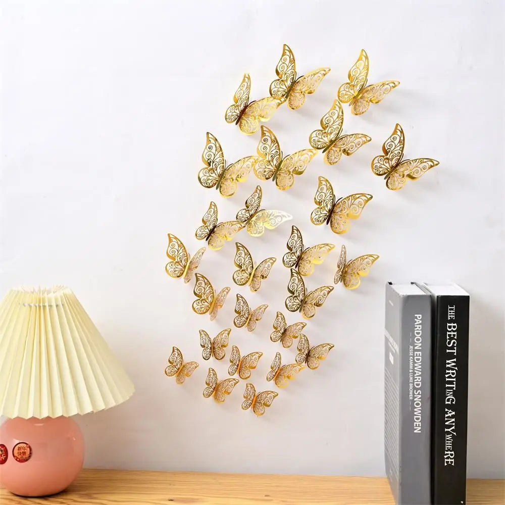 A set of gold-colored 3D hollow butterfly wall decals displayed on a white wall.