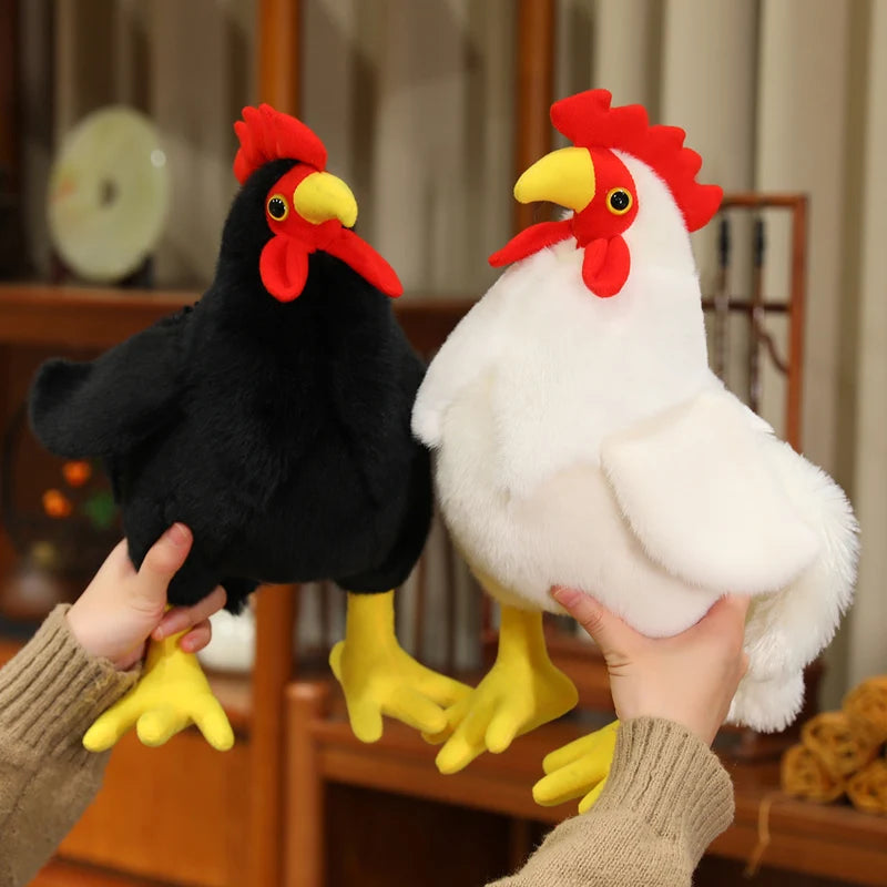 A person is holding a black plush rooster and a white plush rooster.