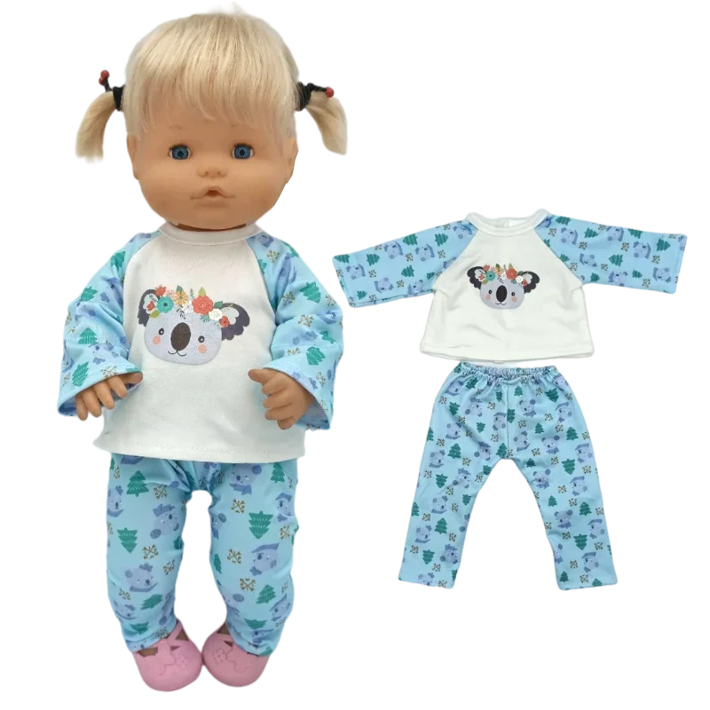 A light-skinned doll wearing a blue and white patterned outfit with a white top, pants, and a matching hat.