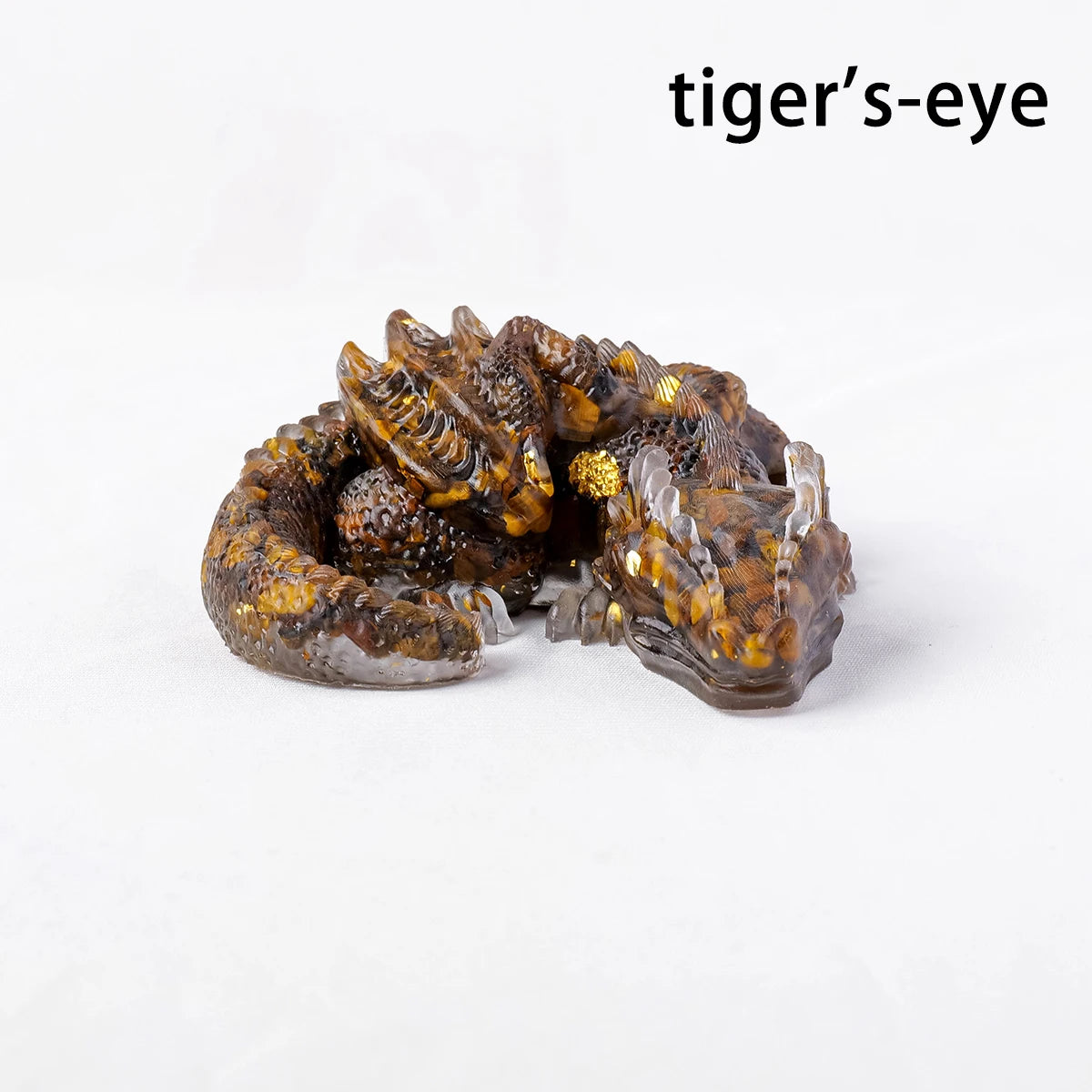A natural crystal dragon figurine with tiger's-eye coloration and texture.