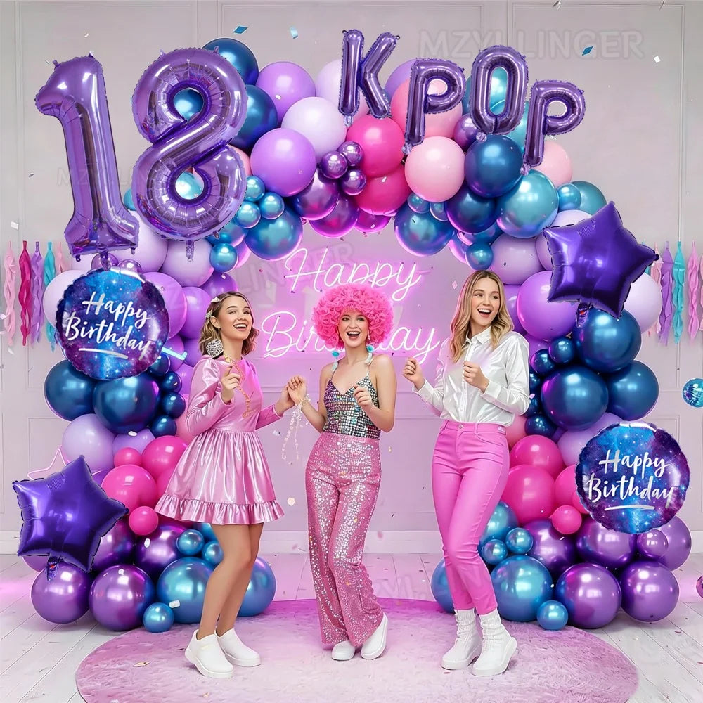 A colorful balloon arch featuring purple and pink balloons with a large foil number 18 and the letters KPOP