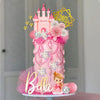A pink princess castle cake topper set featuring a castle, flowers, and a golden star shape for a birthday celebration.