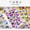A display of butterfly art collage stickers and craft materials for scrapbooking