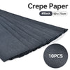 A stack of black crepe paper sheets, 50 x 75cm, shown in a diagonal view.