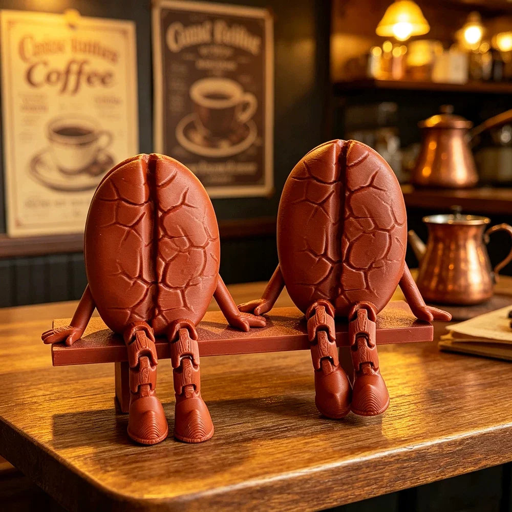 A 3D printed coffee bean cup figurine with articulated joints, brown in color, displayed on a wooden table.