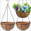 A metal hanging basket with a coconut fiber liner filled with colorful flowering plants.