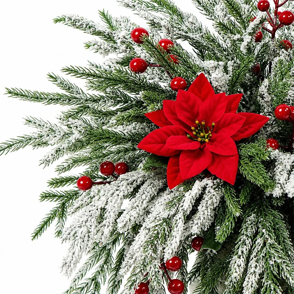 Artificial Norfolk pine branches with red berry stems used for holiday decoration.