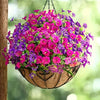 A hanging basket overflowing with vibrant artificial flowers in shades of pink, purple, and magenta.