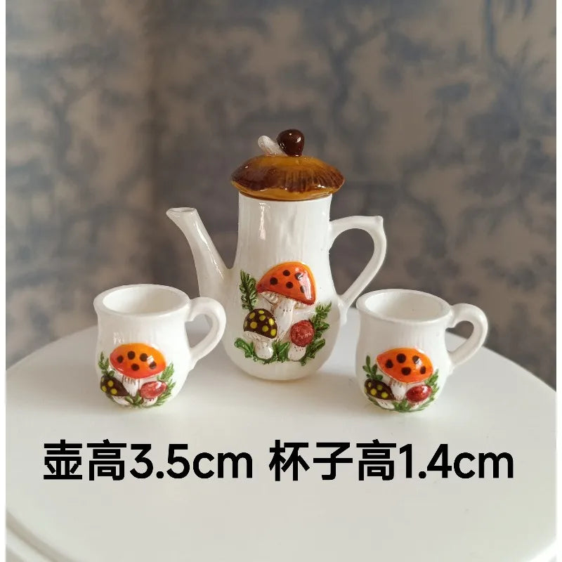 A set of handcrafted miniature ceramic mugs featuring an orange mushroom design on a white background.
