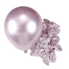 A single, large, iridescent pink latex balloon next to a cluster of crinkled metallic silver balloons for party decor.