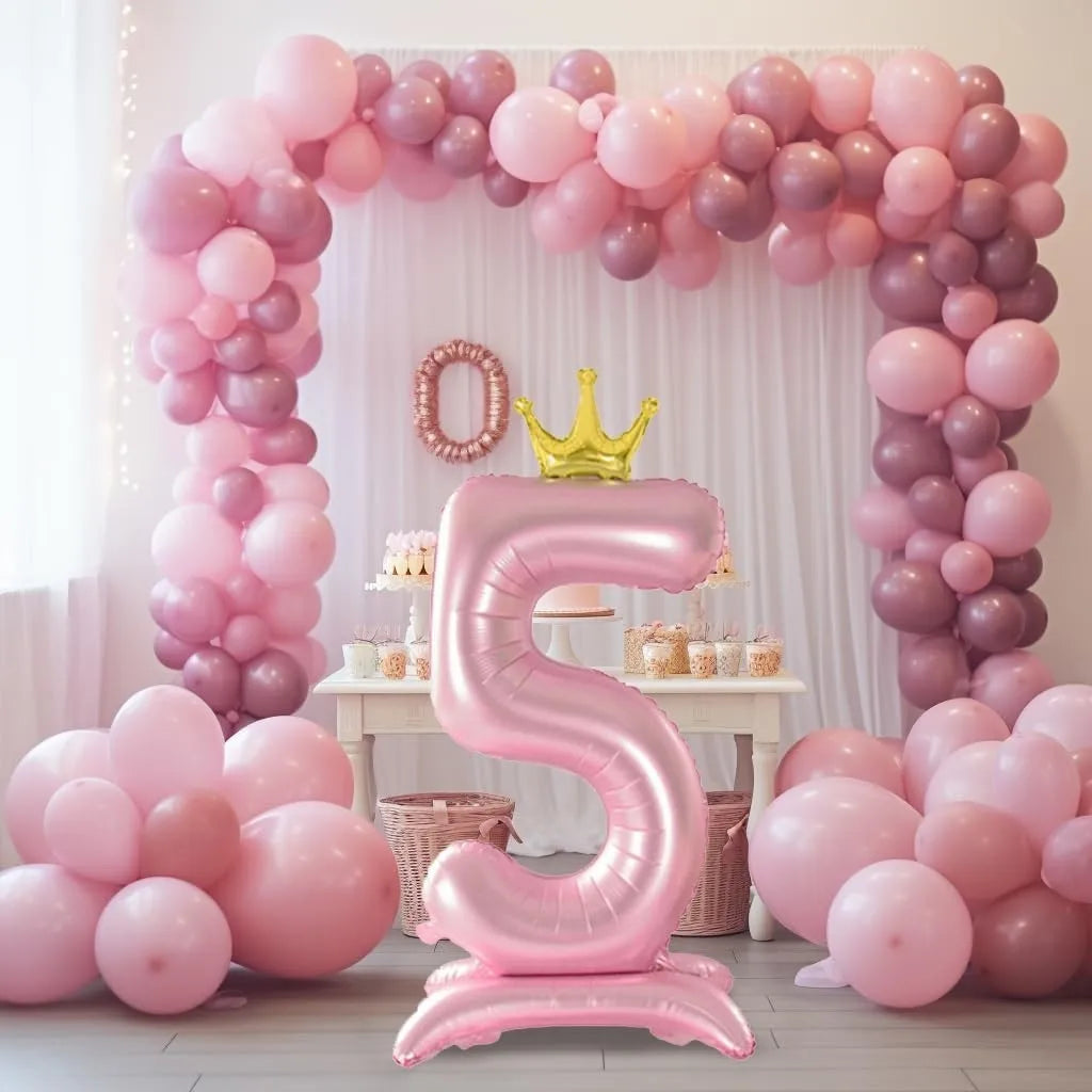 A large pink foil balloon number 5 is displayed in a balloon arch setup with various pink and mauve balloons.
