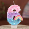 Rainbow sequined number candle shaped like the number 6 for a birthday cake