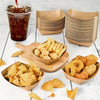 A collection of food items including chips, french fries, and fried seafood served in kraft paper disposable trays.