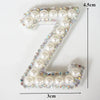 A white rhinestone patch shaped like the letter Z, measuring 4.5cm high and 3cm wide.