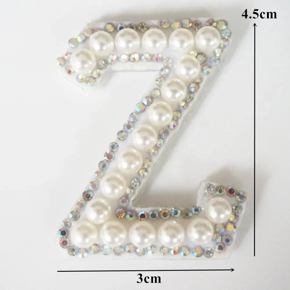 A white rhinestone patch shaped like the letter Z, measuring 4.5cm high and 3cm wide.