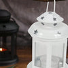 A white vintage hanging metal lantern with a glass enclosure and star accents is displayed against a dark background.
