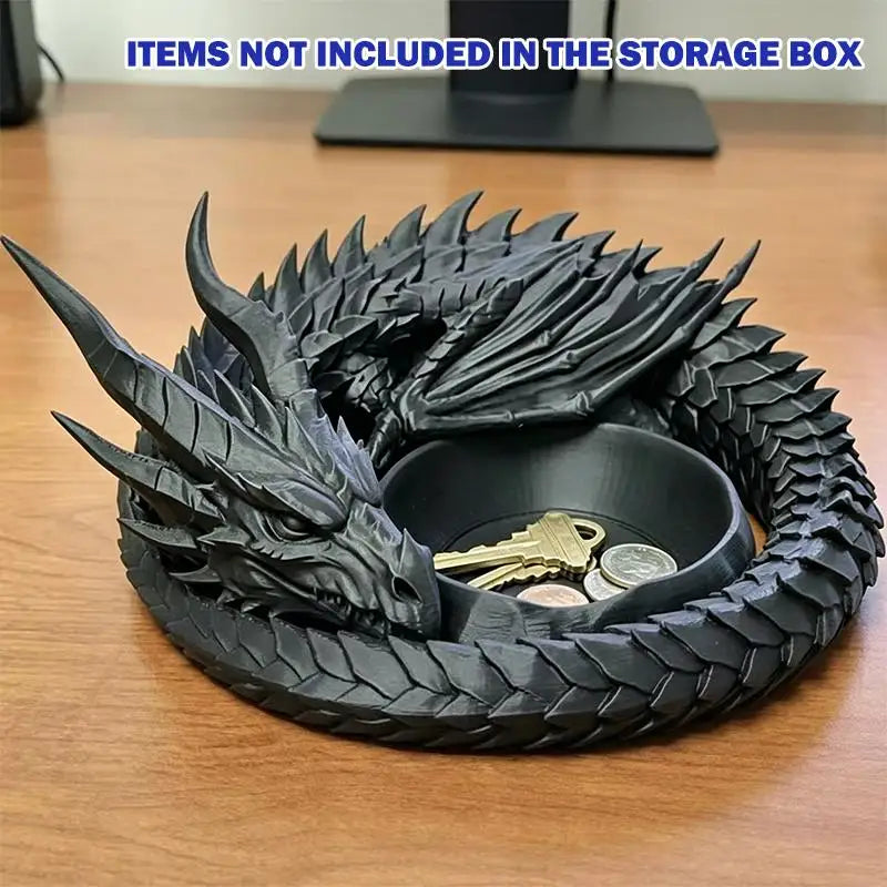 A black dragon design decorative tray for jewelry and small items resting on a wooden surface.