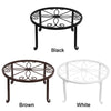 Three decorative metal plant stands in black, brown, and white finishes.