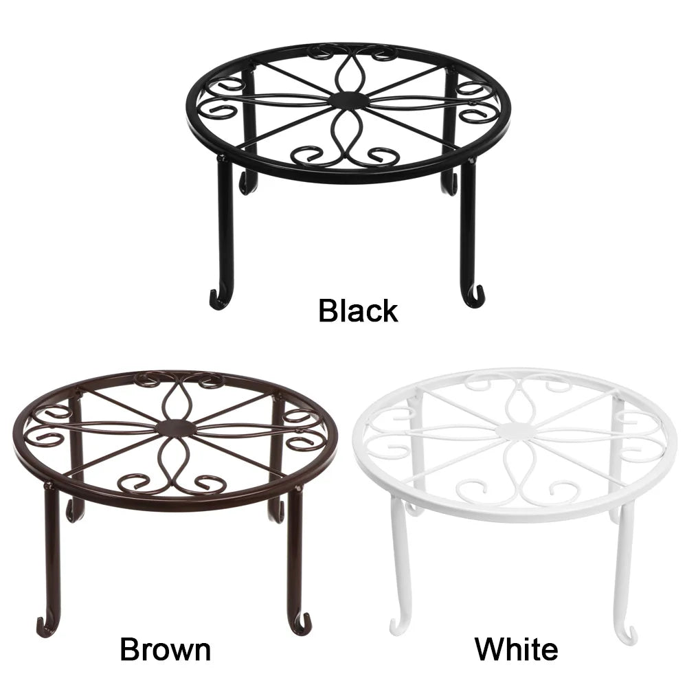 Three decorative metal plant stands in black, brown, and white finishes.