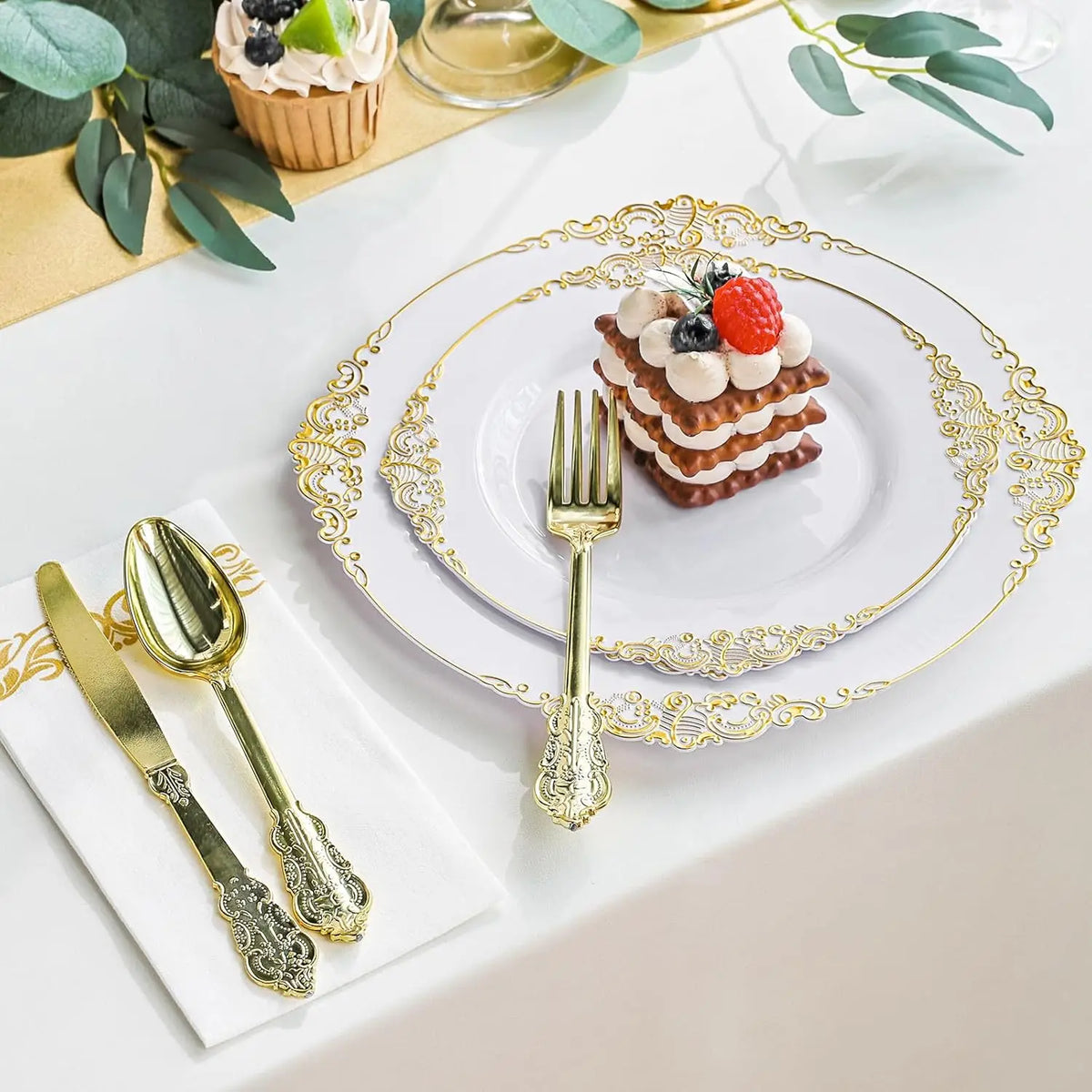Elegant white and gold disposable dinnerware set with cutlery featuring a dessert and fruit