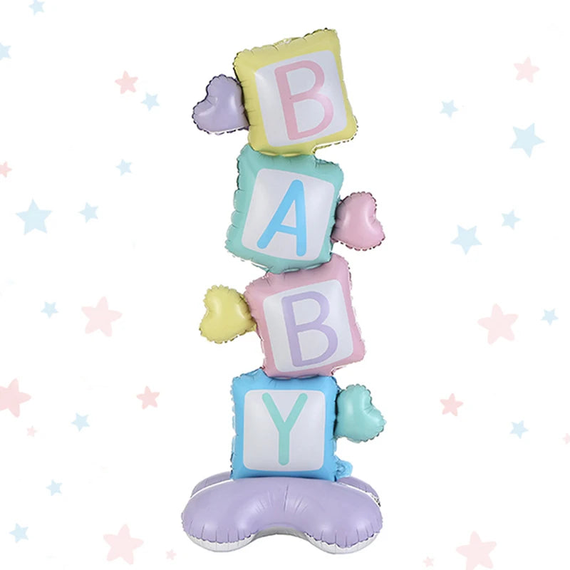 A stack of foil balloons shaped like letters B, A, and Y on a purple balloon for a gender reveal party.