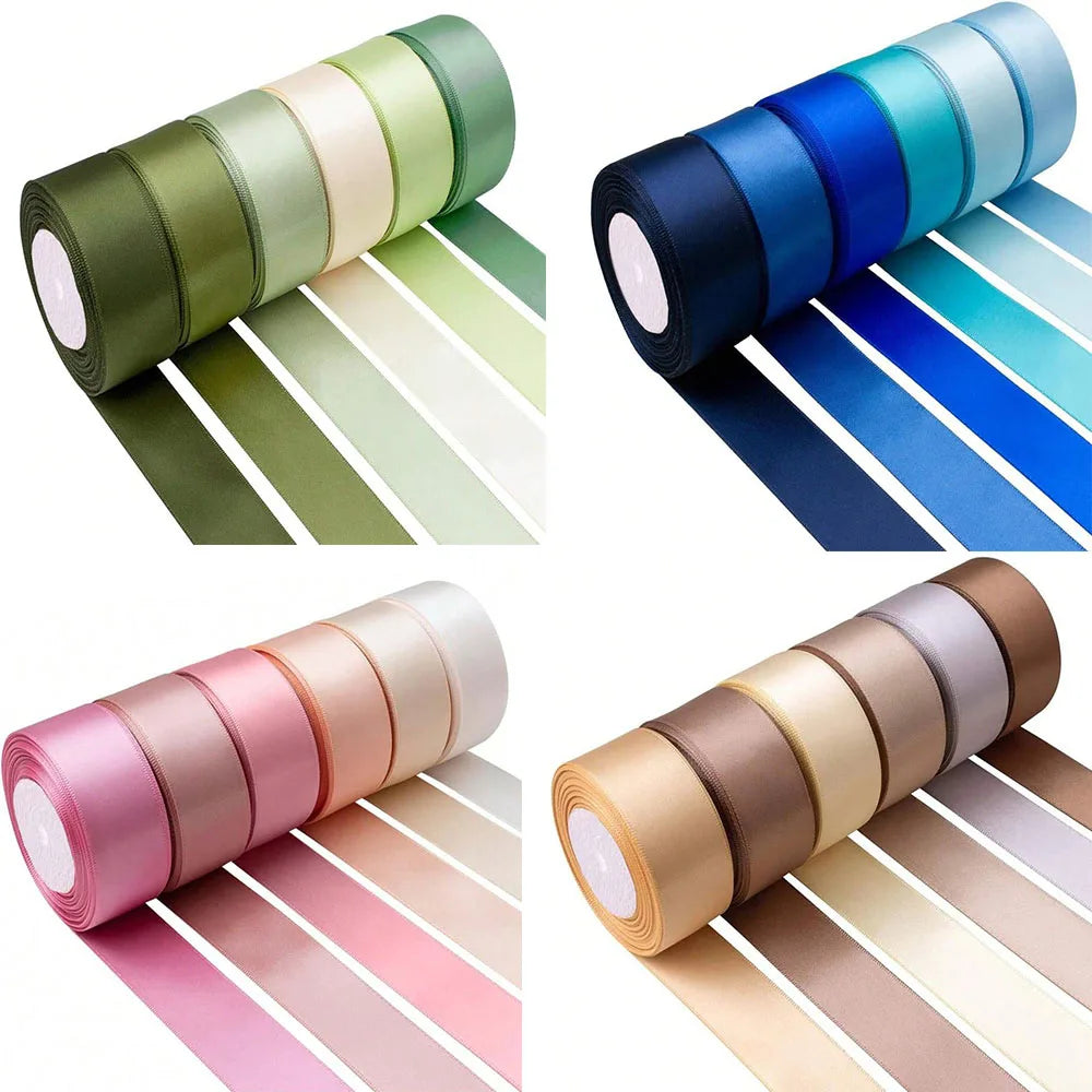 A set of satin silk ribbons in various shades of green, blue, pink, and beige rolled for crafting